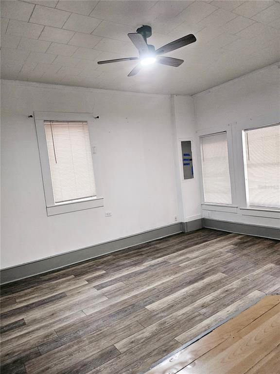 10250 Southeast 108th Terrace Road Ocala, FL 34472 - Photo 8 of 11 a view of empty room with wooden floor and fan