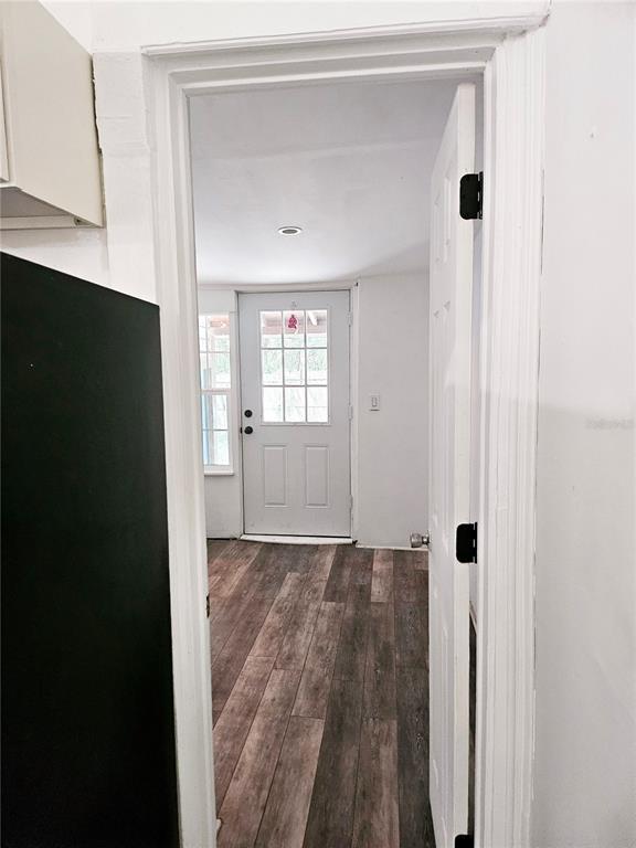 10250 Southeast 108th Terrace Road Ocala, FL 34472 - Photo 10 of 11 a view of a hallway with wooden floor and a bathroom