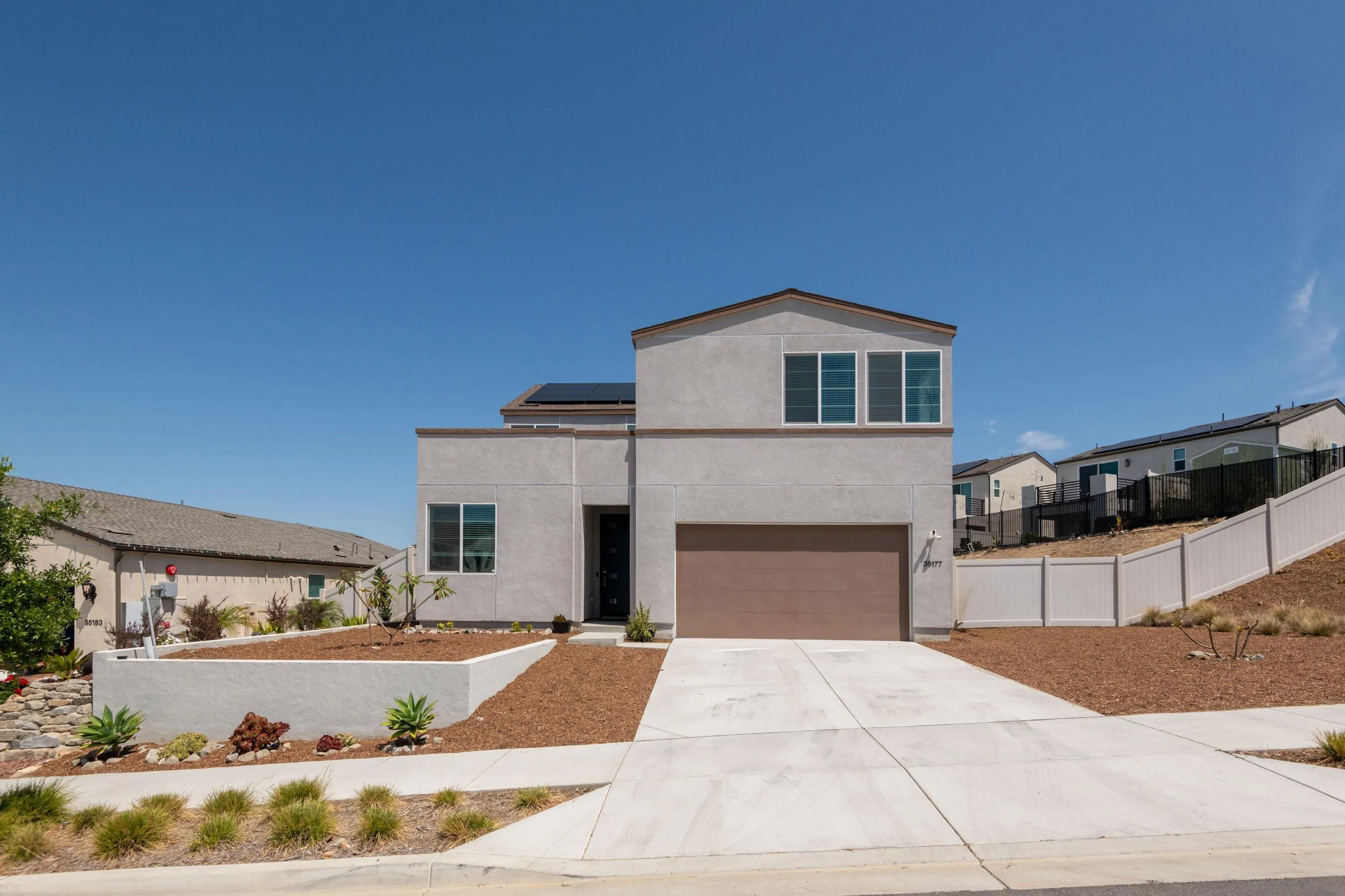 a front view of a house with a yard