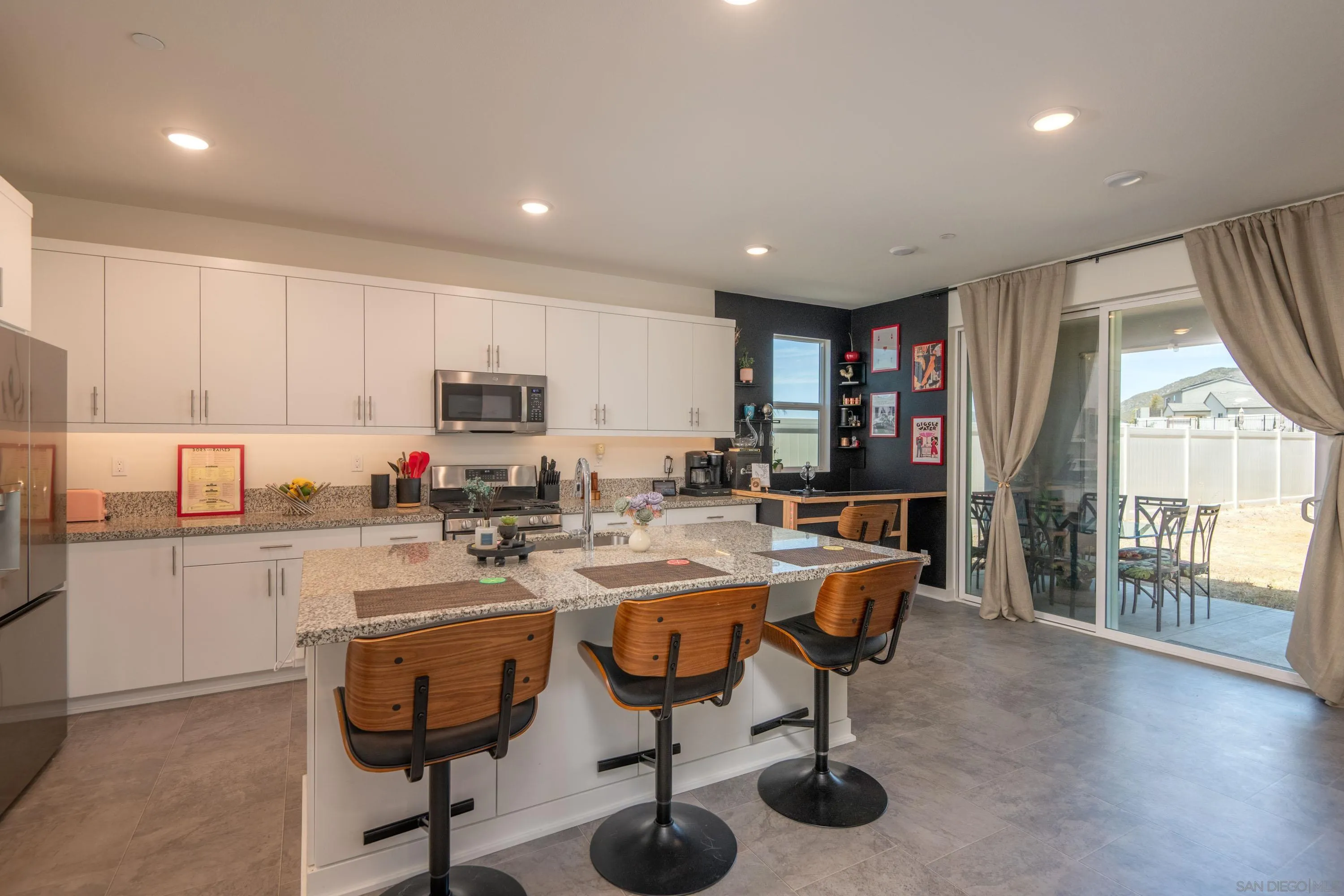 35177 Orchard Trail Fallbrook, CA 92028 - Photo 6 of 31 a kitchen with refrigerator and chairs