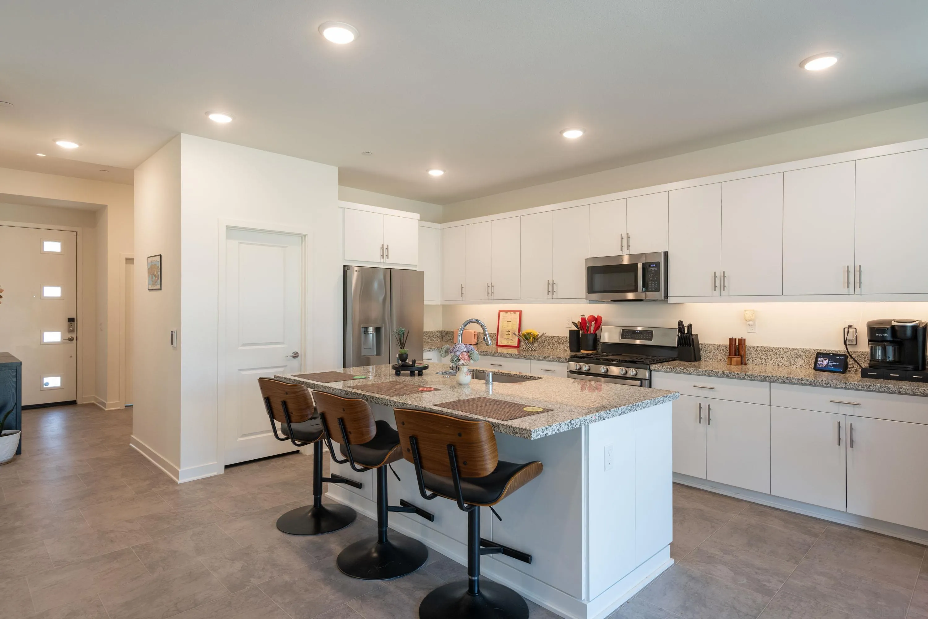 35177 Orchard Trail Fallbrook, CA 92028 - Photo 7 of 31 a kitchen with stainless steel appliances granite countertop a table chairs sink refrigerator and cabinets