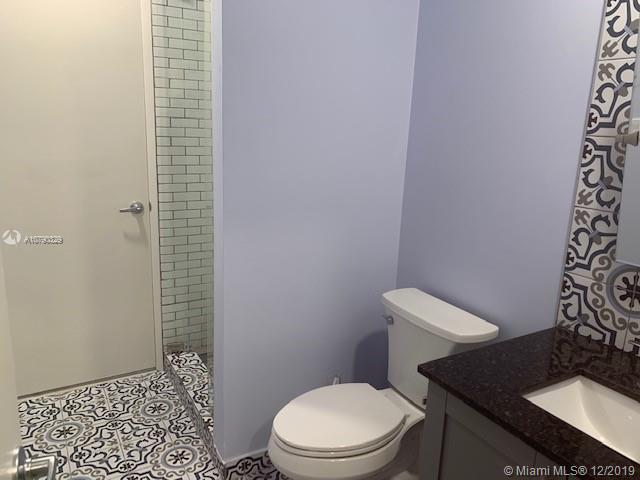 1900 St Andrews Road, Unit 134 Hollywood, FL 33021 - Photo 18 of 29 Newly redone 2nd bathroom with glass enclosed shower, new tiles, new vanity, new mirror, new lighting