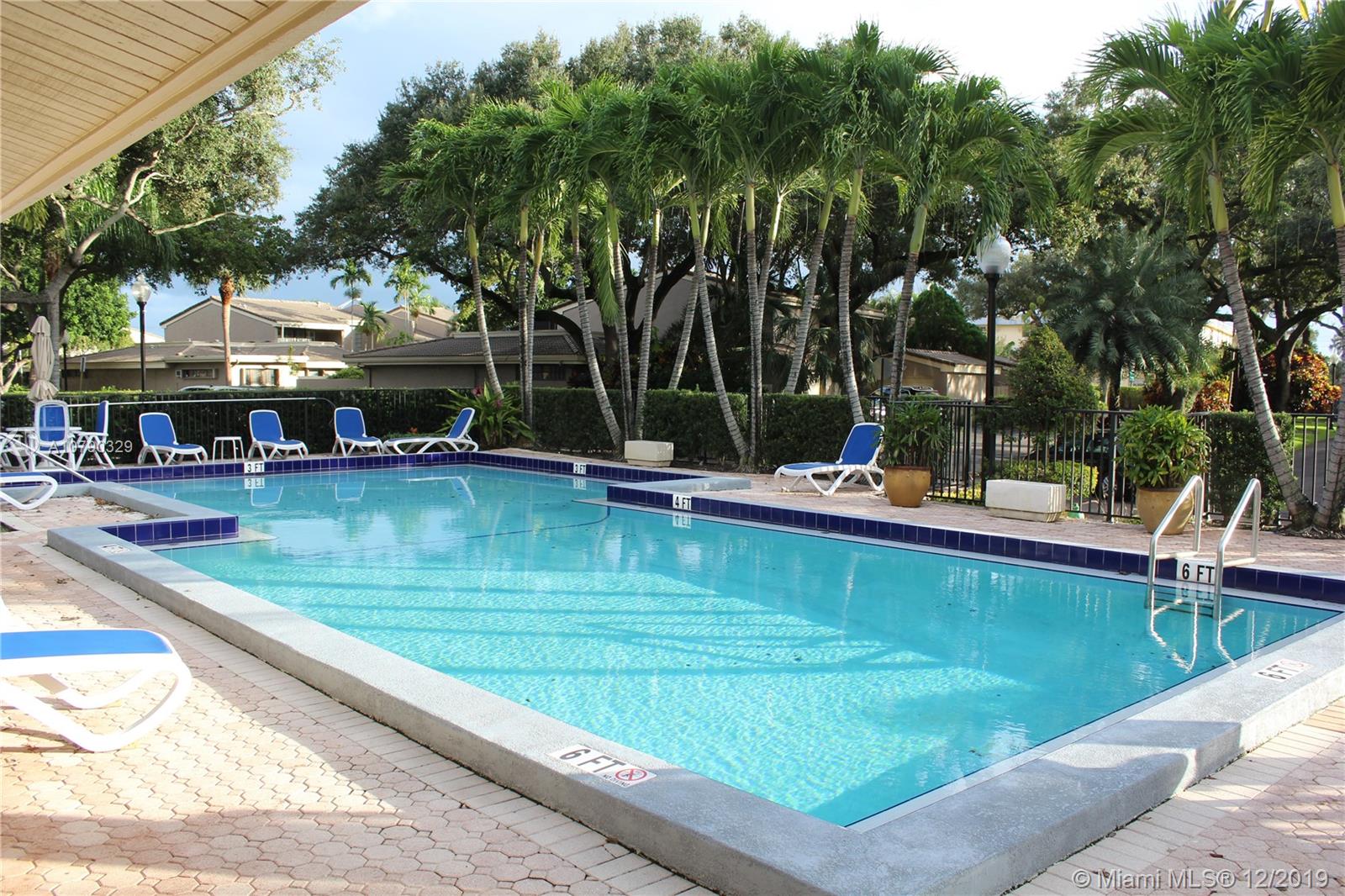 1900 St Andrews Road, Unit 134 Hollywood, FL 33021 - Photo 27 of 29 community pool with clubhouse and gym overlooking golf course