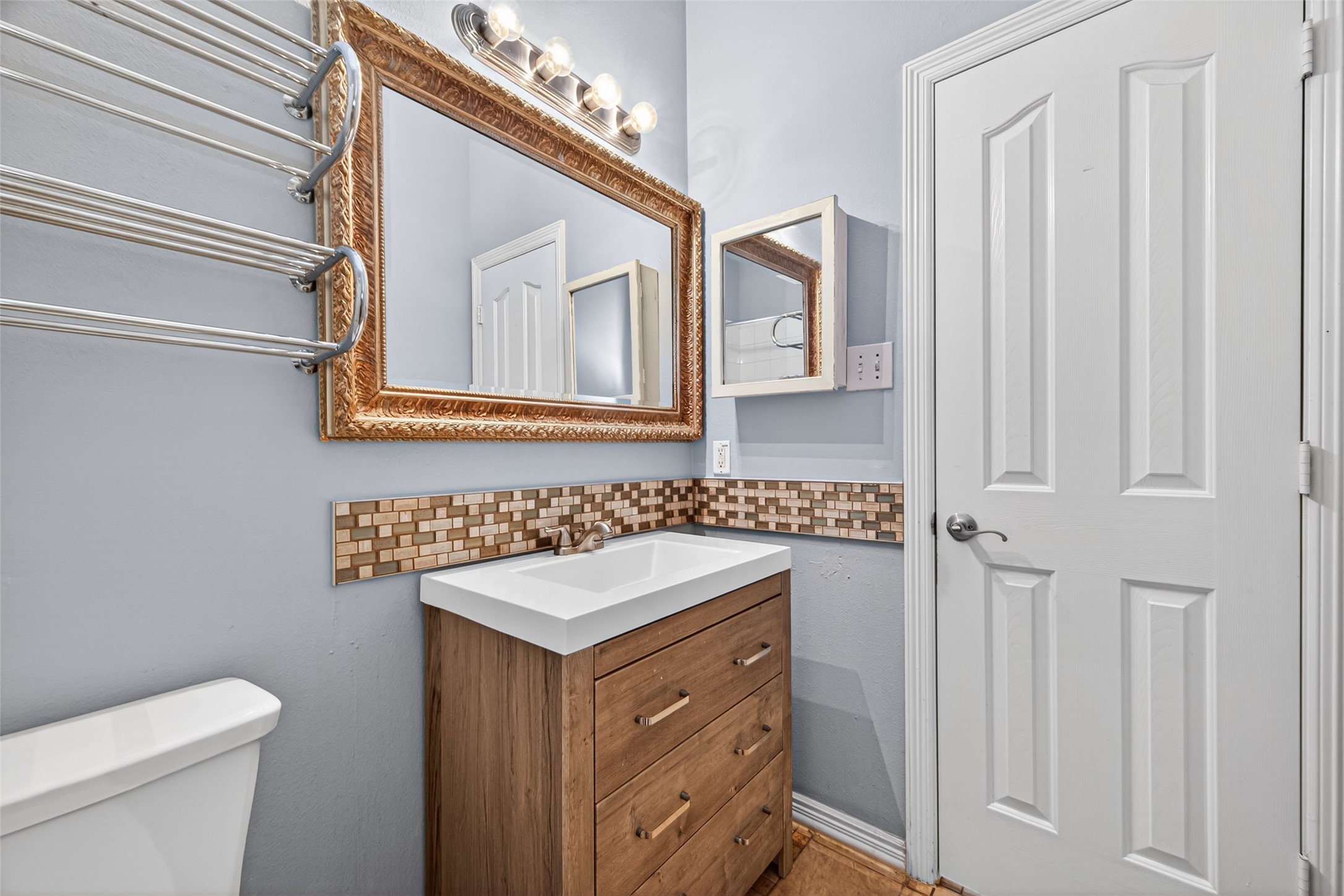 23914 Glengate Drive Spring, TX 77373 - Photo 39 of 49 a bathroom with a sink a toilet and a mirror