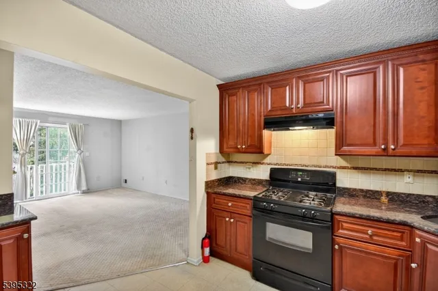 a kitchen with wooden cabinets and a stove top oven