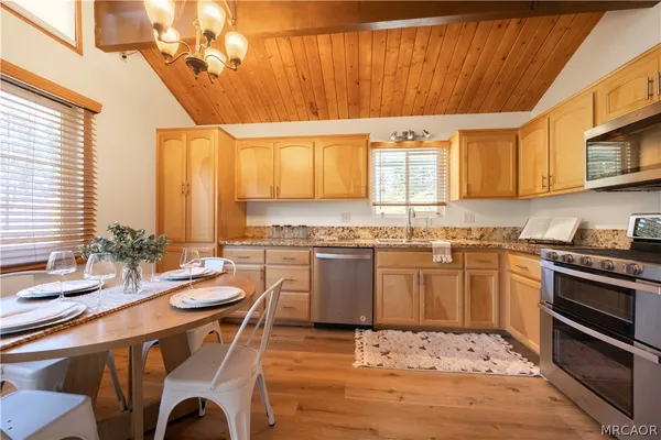 a kitchen with a stove a sink and a refrigerator