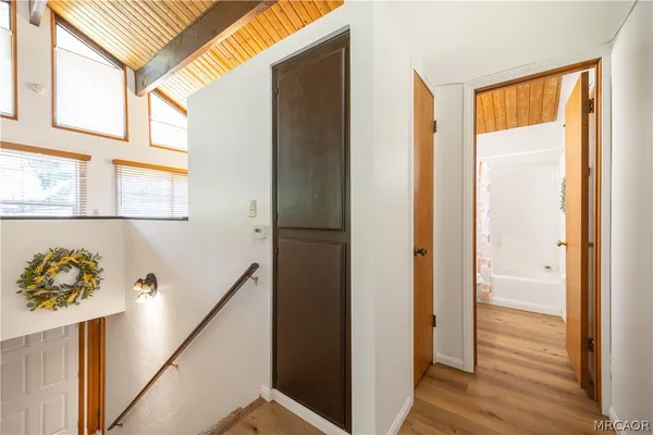 a view of hallway with wooden floor and stairs