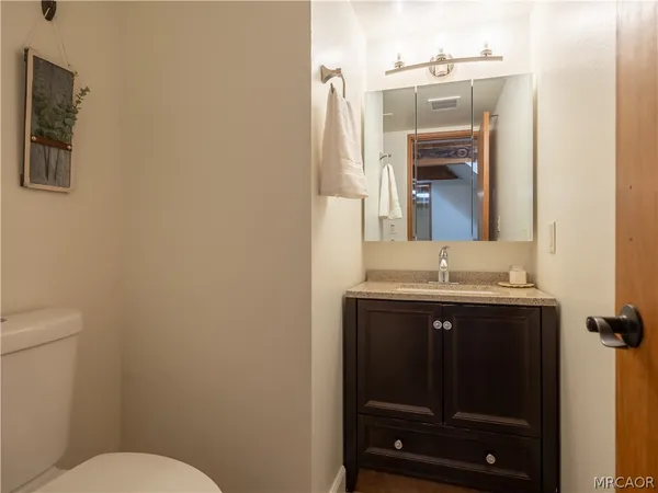 a bathroom with a sink a toilet and mirror