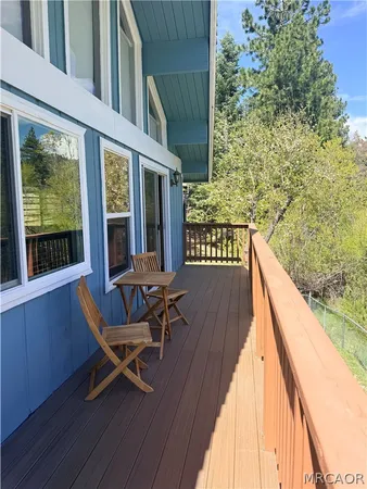 a view of a wooden chairs in a balcony
