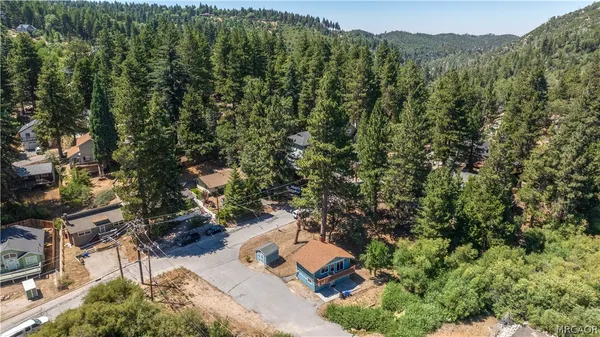 an aerial view of a house with yard