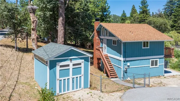 a aerial view of a house with a yard and balcony