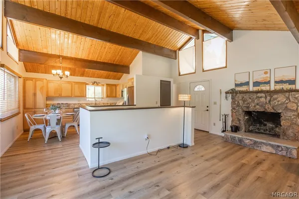 a living room with furniture a fireplace and wooden floor