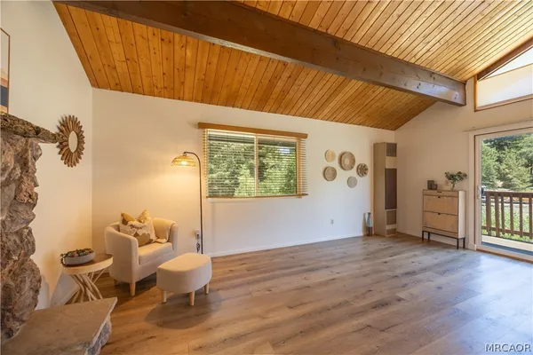 a view of a room with wooden floor and furniture