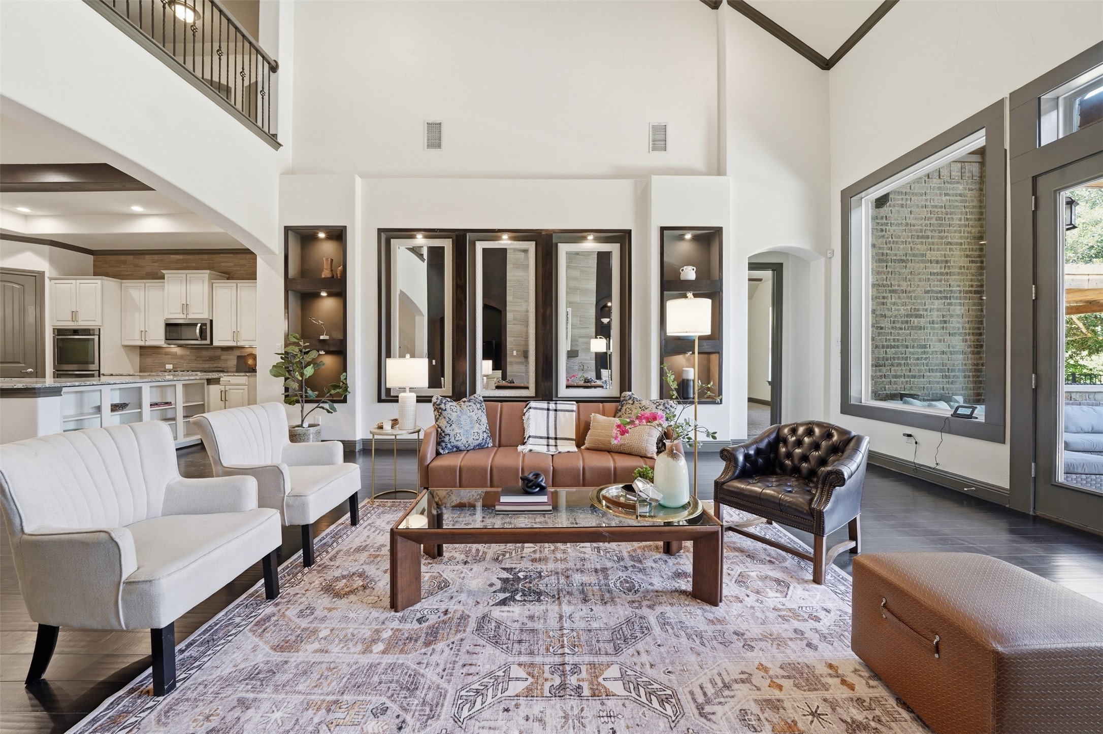 8729 Vantage Point Drive Austin, TX 78737 - Photo 12 of 33 An airy living area connects to an open-concept kitchen, featuring rich wood floors and tall ceilings.