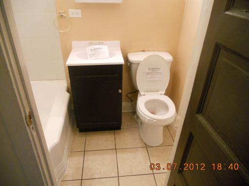7108 South Normal Boulevard Chicago, IL 60621 - Photo 11 of 15 a bathroom with a toilet and a sink