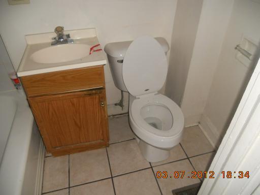 7108 South Normal Boulevard Chicago, IL 60621 - Photo 5 of 15 a bathroom with a toilet and a sink