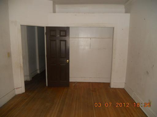 7108 South Normal Boulevard Chicago, IL 60621 - Photo 8 of 15 a view of hallway with wooden floor