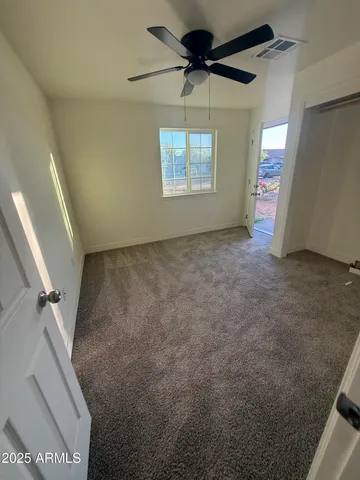 a view of a livingroom with a ceiling fan and window