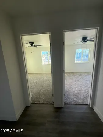 an empty room with wooden floor and door