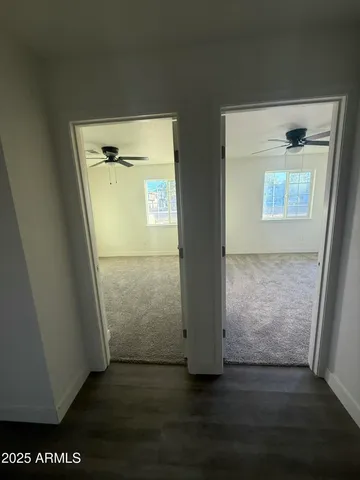 an empty room with wooden floor and door