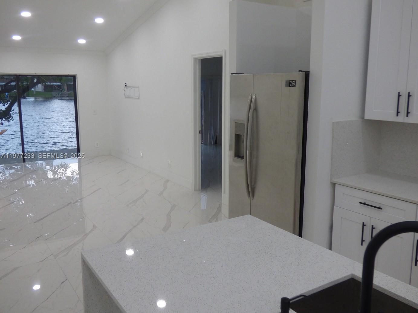 a bedroom with a bed and a refrigerator