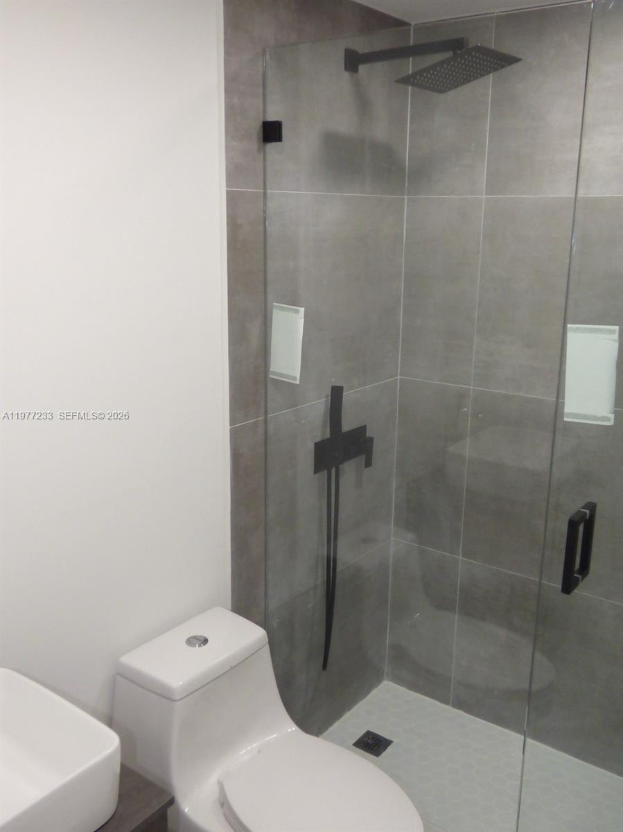 5643 North Park Road Dania Beach, FL 33312 - Photo 2 of 9 a bathroom with a toilet and a shower