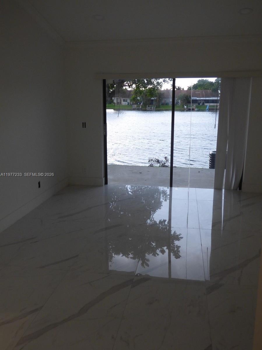 5643 North Park Road Dania Beach, FL 33312 - Photo 6 of 9 a view of an empty room with floor to ceiling window and an entrance