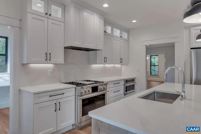 a view of an empty room with a fireplace and a window