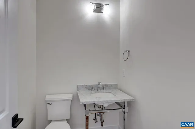 a bathroom with a sink mirror vanity and toilet
