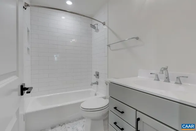 a spacious bathroom with a double vanity sink a large mirror a bathtub and window