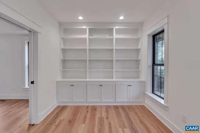 a view of a room with wooden floor chandelier and entryway