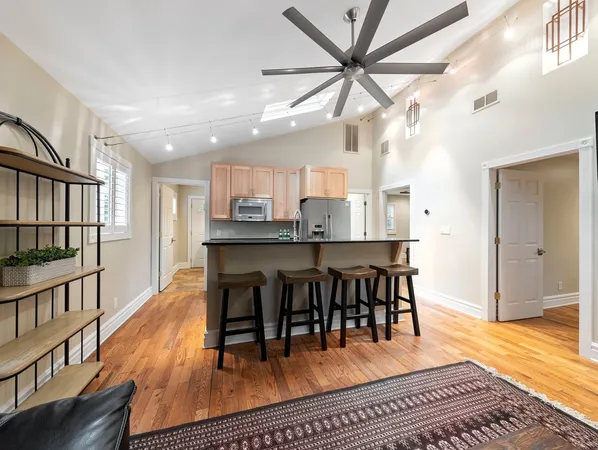a view of a dining room with furniture a rug and wooden floor
