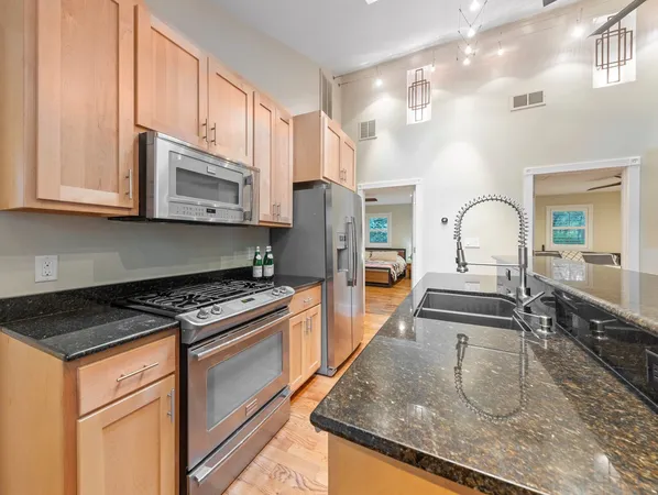 a kitchen with stainless steel appliances granite countertop a stove and a sink
