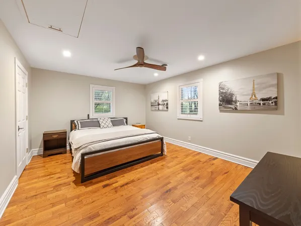 a spacious bedroom with a bed and a desk