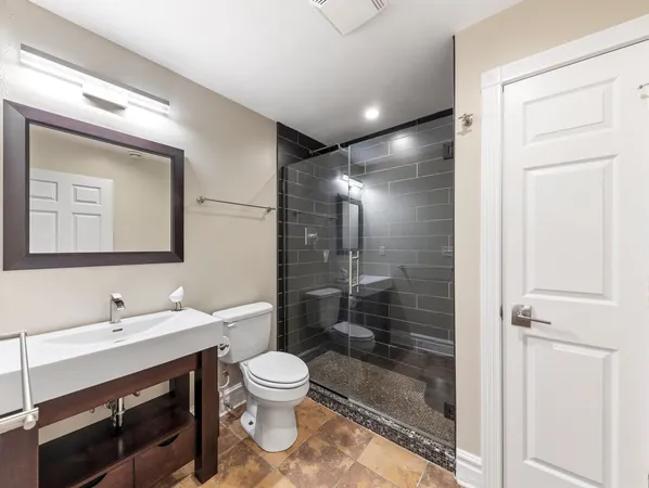 a bathroom with a toilet sink and shower