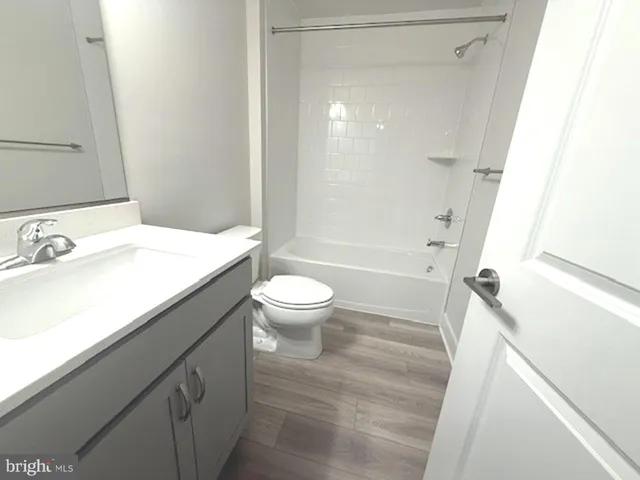 a bathroom with a sink a toilet a mirror and shower