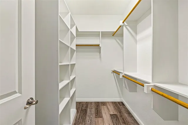 a view of walk in closet with empty racks