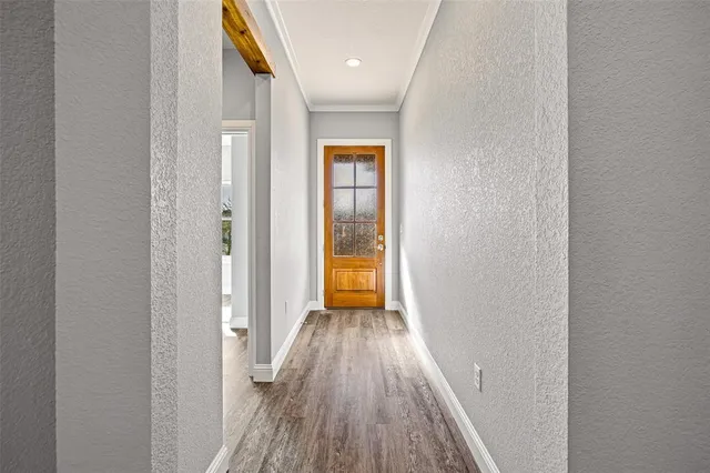 a view of a hallway with wooden floor
