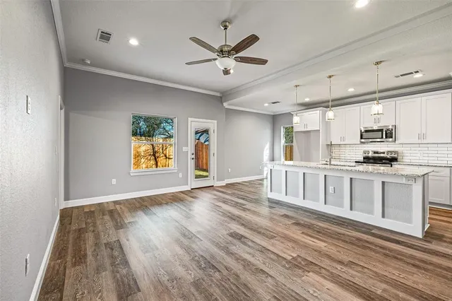 a view of kitchen with sink and wooden floor
