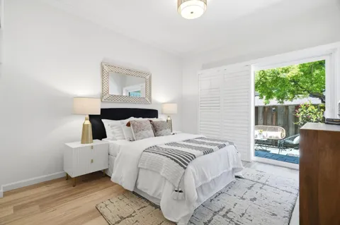 a bedroom with a large bed and a window