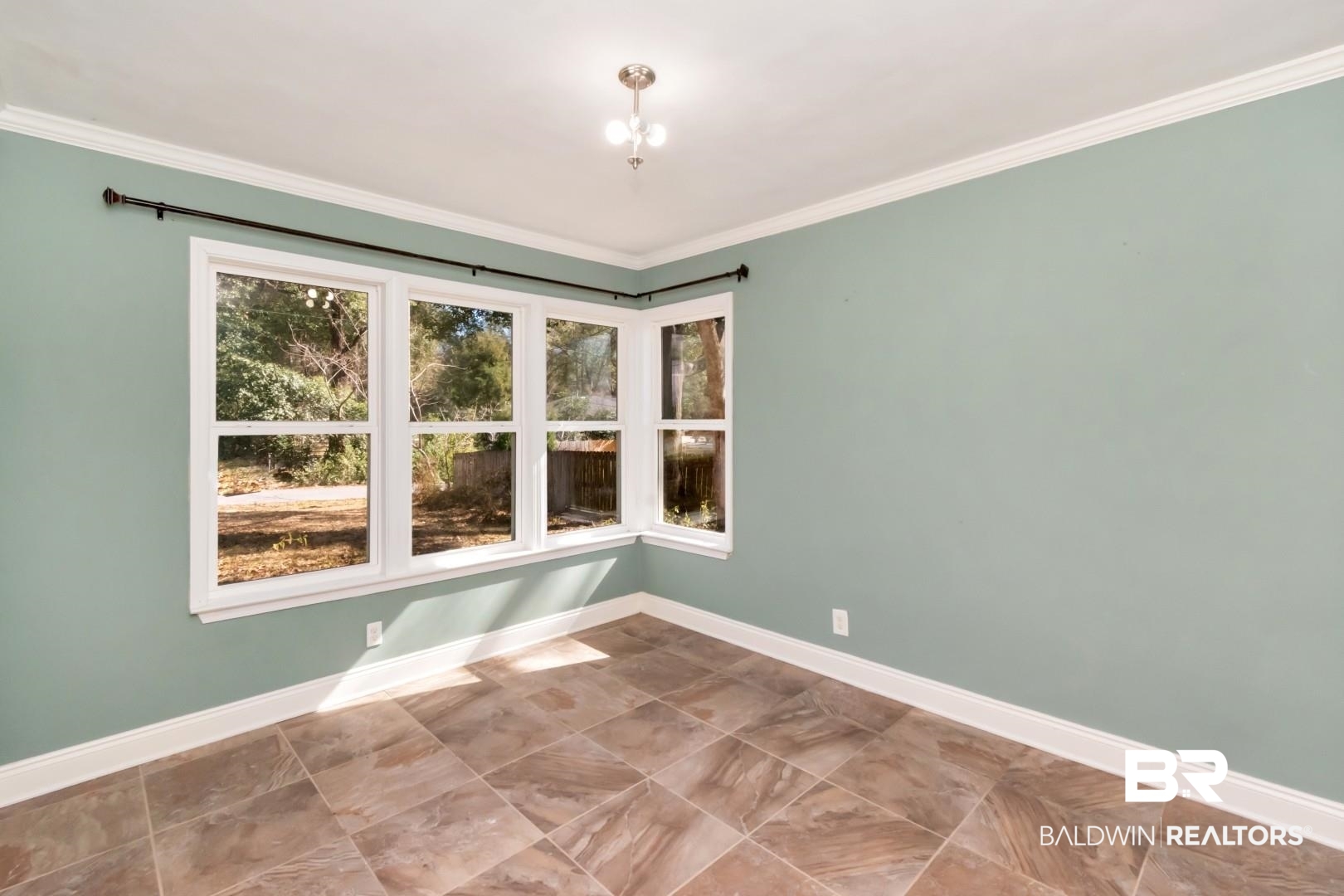 410 St John Place Mobile, AL 36609 - Photo 18 of 32 Empty room featuring baseboards and ornamental molding