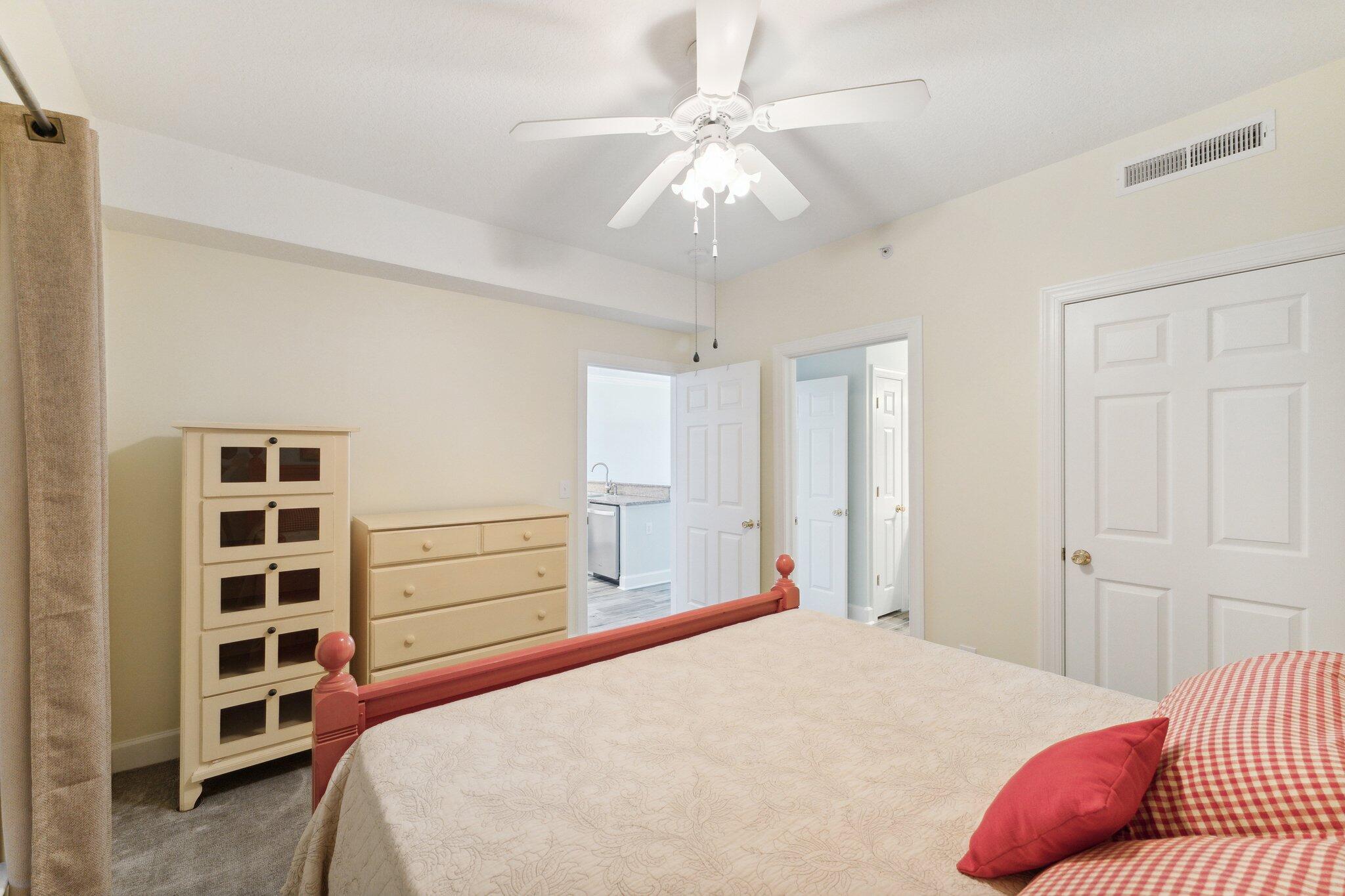 17545 Front Beach Road, Unit 2103 Panama City Beach, FL 32413 - Photo 14 of 56 a bedroom with a bed and cabinets