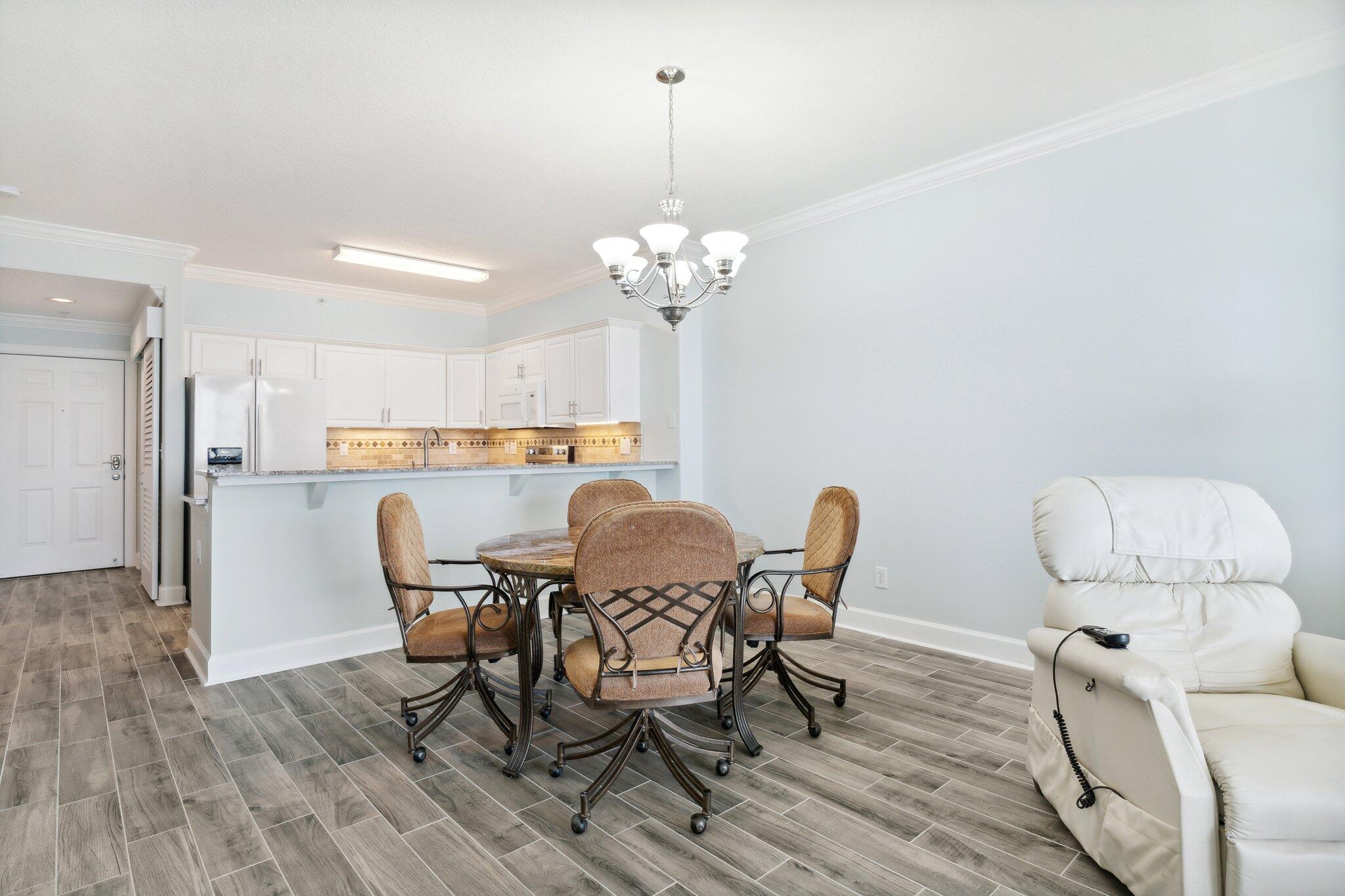 17545 Front Beach Road, Unit 2103 Panama City Beach, FL 32413 - Photo 17 of 56 a dining room with furniture and window