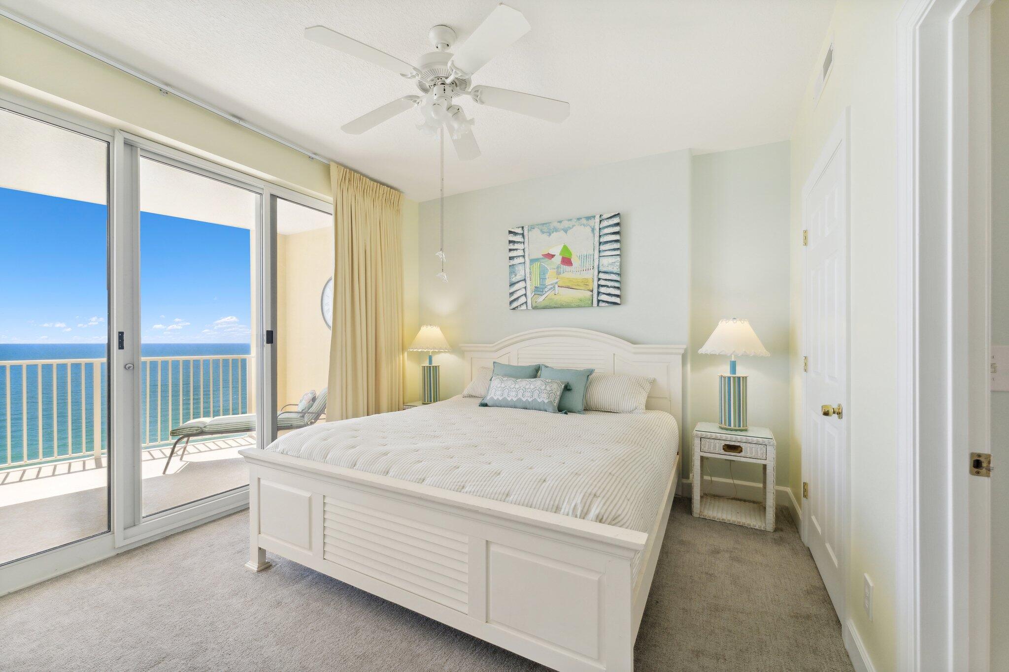 17545 Front Beach Road, Unit 2103 Panama City Beach, FL 32413 - Photo 21 of 56 a bedroom with a bed and a chandelier