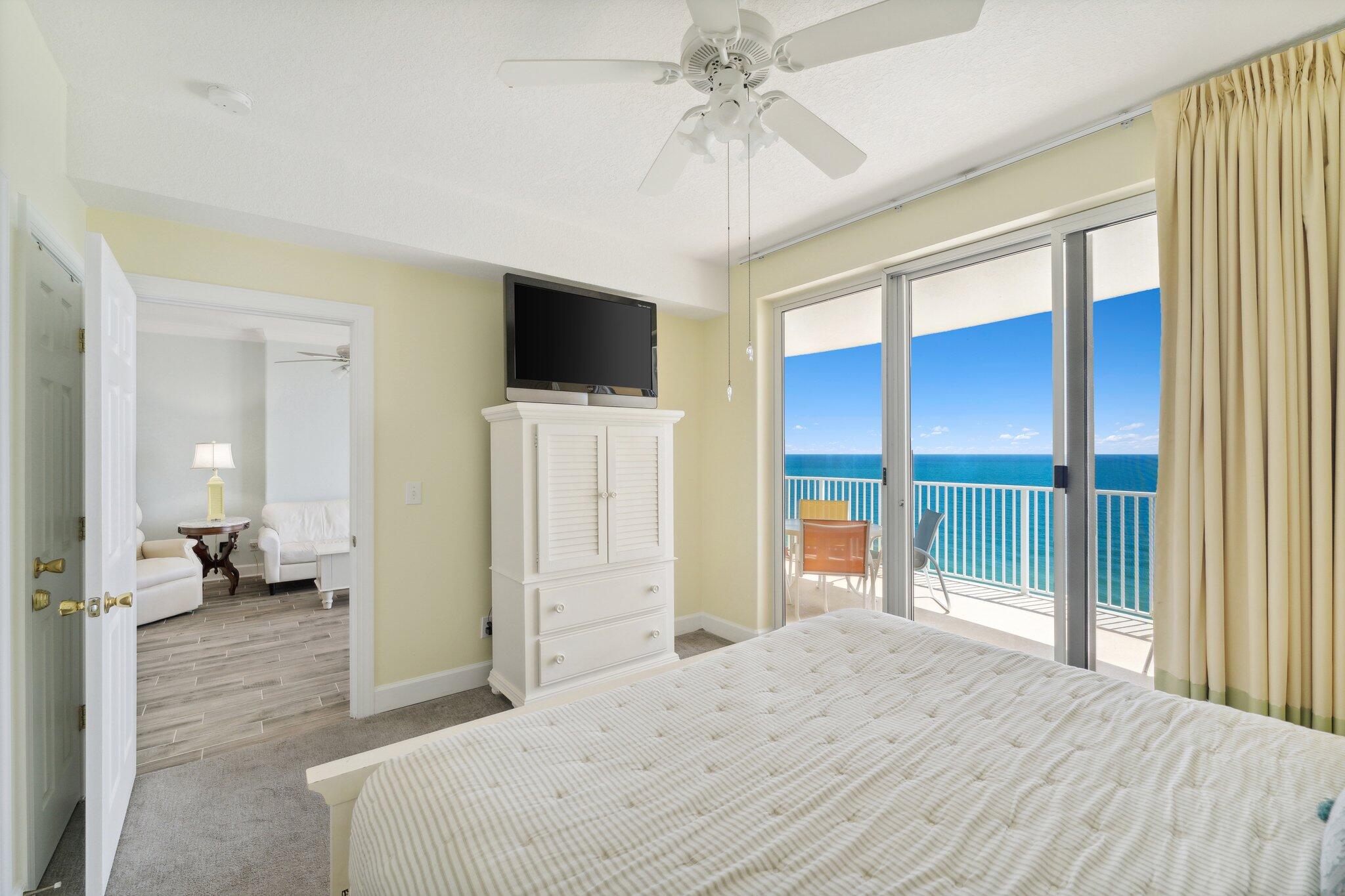 17545 Front Beach Road, Unit 2103 Panama City Beach, FL 32413 - Photo 22 of 56 a bedroom with a bed and a flat screen tv