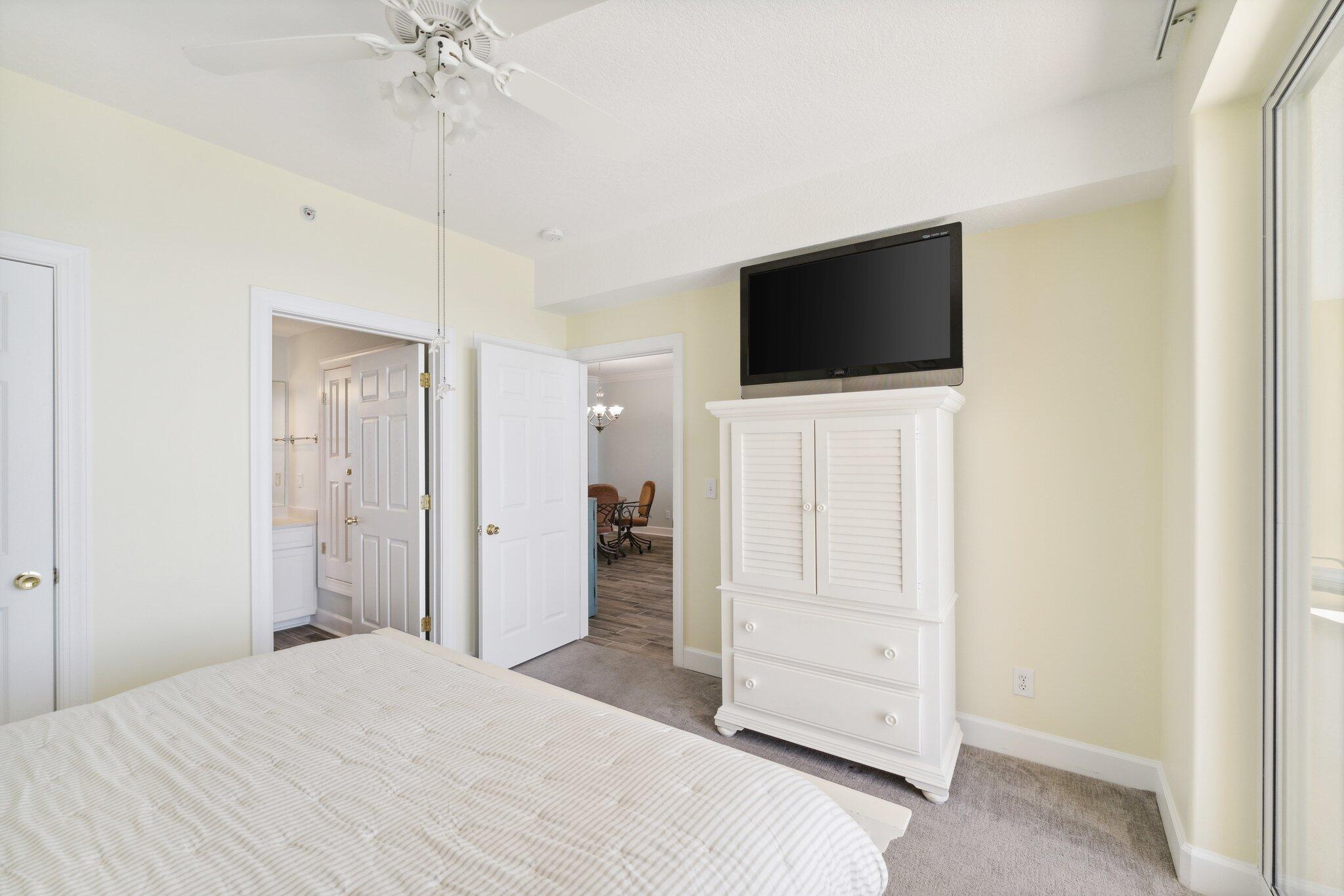 17545 Front Beach Road, Unit 2103 Panama City Beach, FL 32413 - Photo 24 of 56 a bedroom with a bed and a flat screen tv