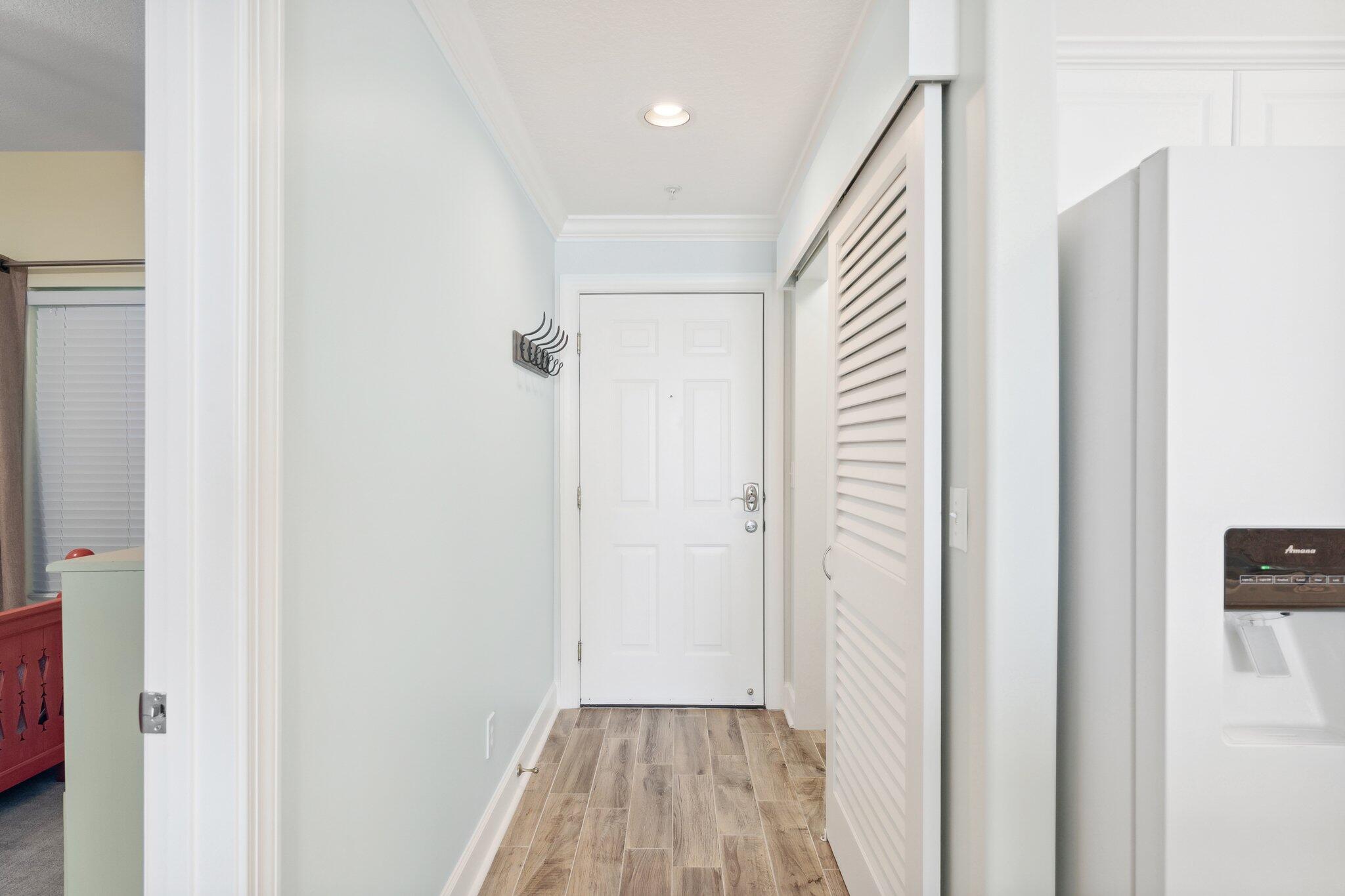 17545 Front Beach Road, Unit 2103 Panama City Beach, FL 32413 - Photo 8 of 56 a view of a hallway with wooden floor and a bathroom