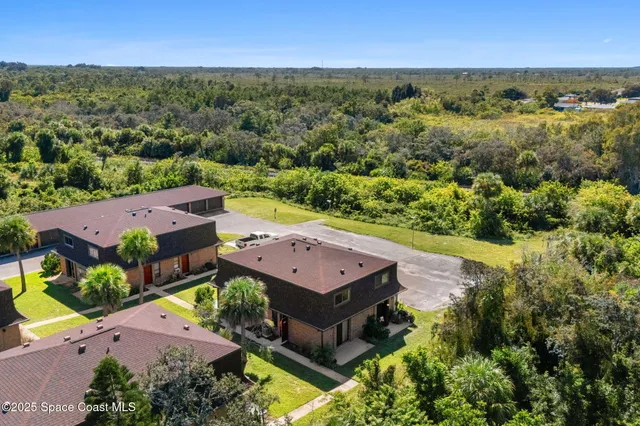 an aerial view of a house with a garden