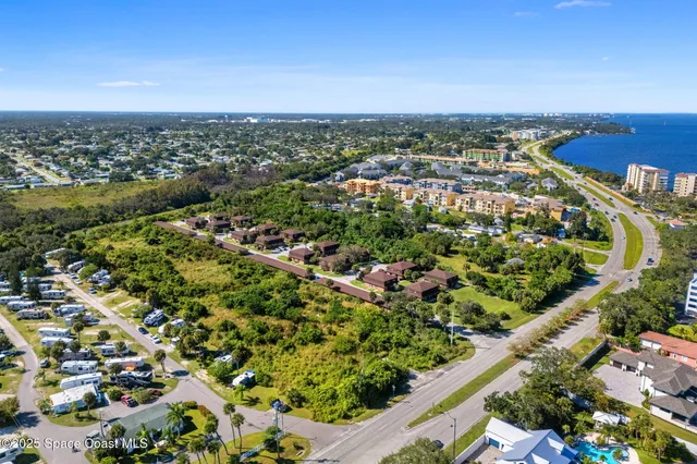 an aerial view of a residential houses with city view