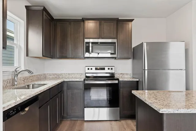 a kitchen with a sink stove and refrigerator